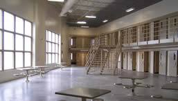 image of the inside of the washington state penitentiary north close custody expansion, showing a common area and cell doors.