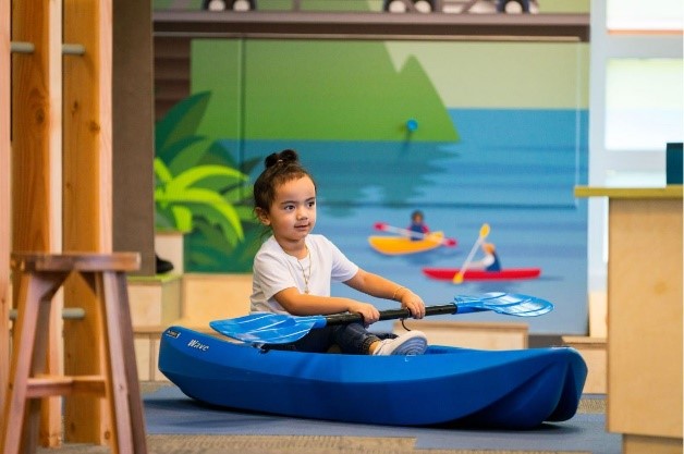 A child sitting in a Kayak