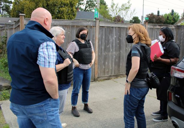 A group of people talk outside before visiting a person taking part in the Parent Sentencing Alternative program