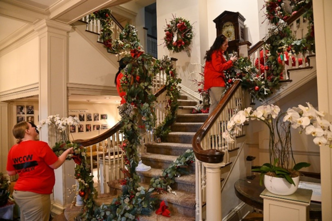 Women decorating a stairwell.