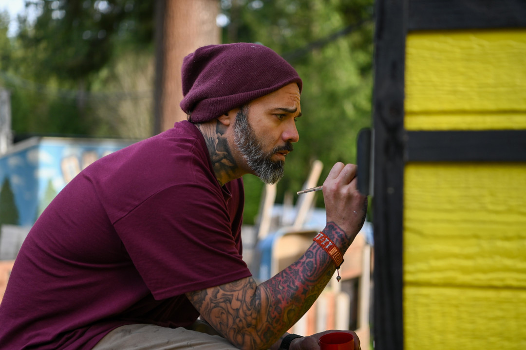 Man focusing intently while painting.