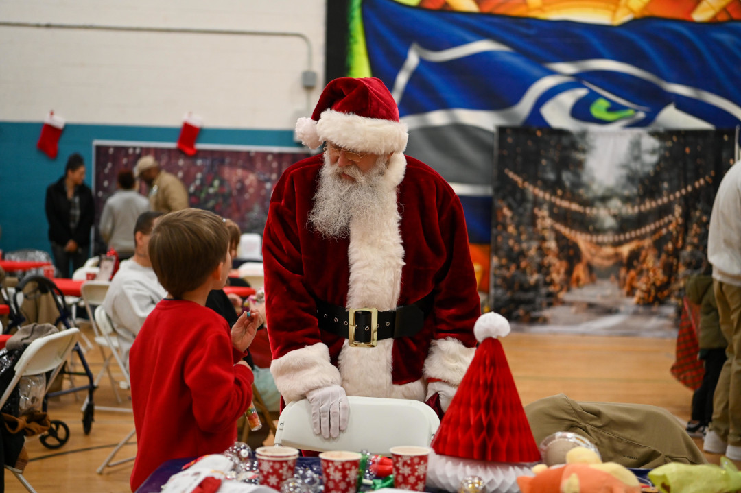 Little boy talking to Santa Claus.