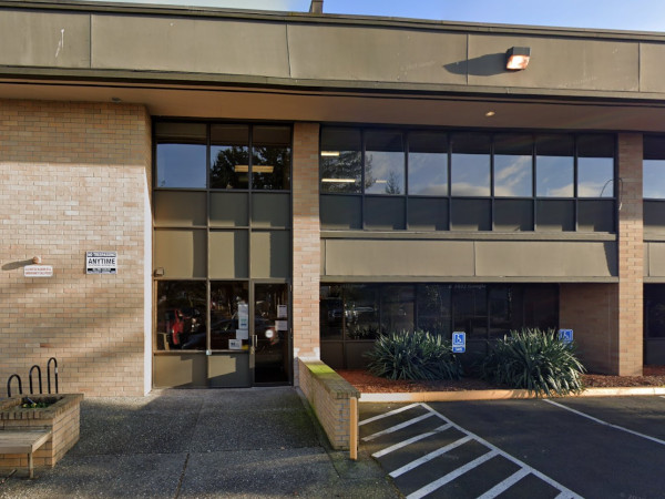 image of the outside of the Everett community justice center with people near garden beds