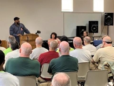 Seattle Clemency Project (SCP) and Department of Corrections (DOC) Resentencing at a workshop for incarcerated individuals. Pictured left to right: SCP Marcus Price, SCP Jordan Casey, and DOC Maurya Ayala