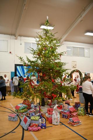 a christmas tree with presents under it