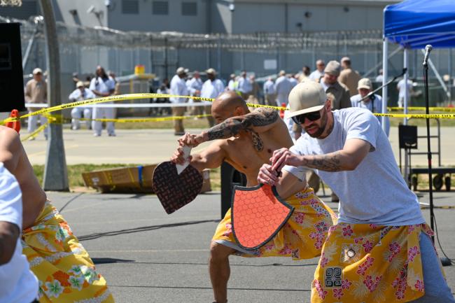 Incarcerated individuals singing, dancing and enjoying festivities.